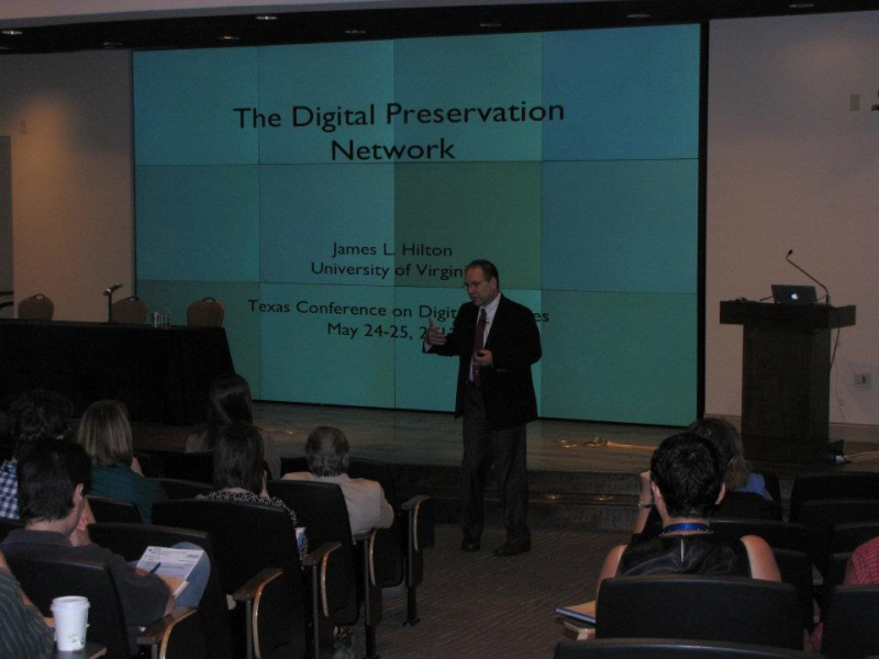 James Hilton stands in front of an audience for his presentation "The Digital Preservation Network".