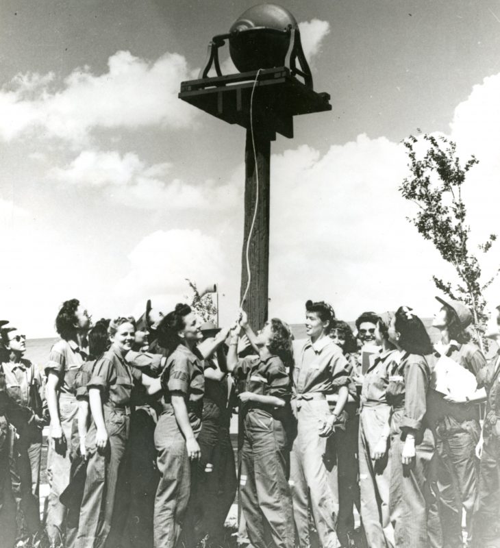 Avenger Field, Sweetwater, Texas. Class 43-W-5 rings the bell signifying the completion of ground school.