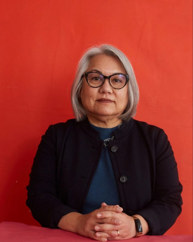 Photo of Patricia Hswe against a red background.